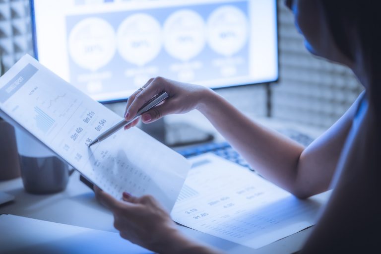 Asian,Business,Woman,Reviewing,Data,In,Financial,Charts,And,Graphs.